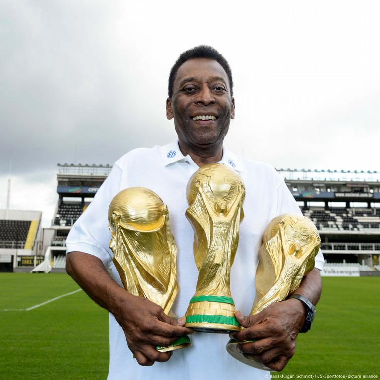 Pelé feliz con tres copas del mundo en sus manos